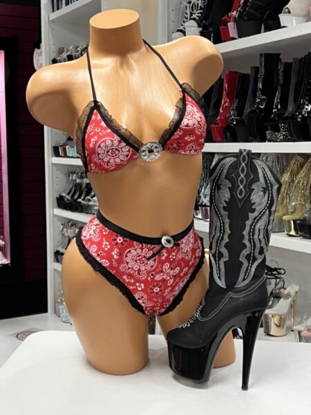 Red Bandana Bikini Set featuring a western-inspired bandana print, decorative concho accents, black ruffle trim, triangle bikini top, and high-waisted bikini bottoms.