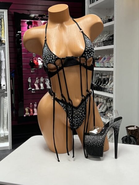 Black O Ring String Bikini featuring rhinestone embellished cups, matching thong, polished O-ring hardware, adjustable halter straps, and dramatic hanging strap details.