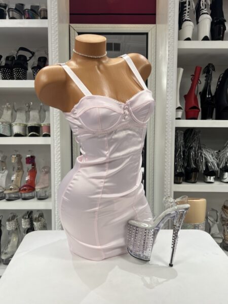 Light pink satin chemise featuring underwire cups, adjustable shoulder straps, decorative front buttons, and a fitted mini silhouette.