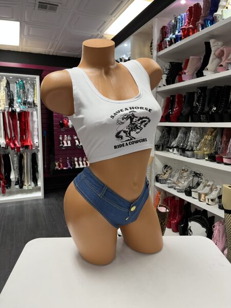 Model wearing blue denim booty shorts with a high-waisted faux denim design and cheeky back.