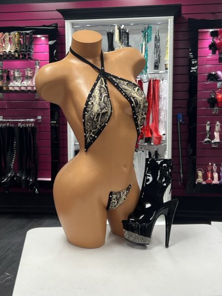 Python Crystal Slingshot featuring snake print fabric, sparkling crystal embellishments, wrap halter neckline, and dramatic open-front silhouette.