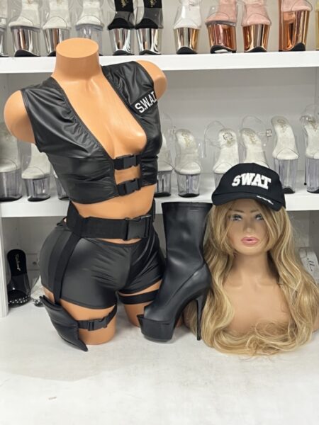 SWAT Costume Set featuring a faux leather tactical crop vest, matching shorts, adjustable utility belt, thigh holster, embroidered SWAT cap, and black platform boots displayed on a mannequin.