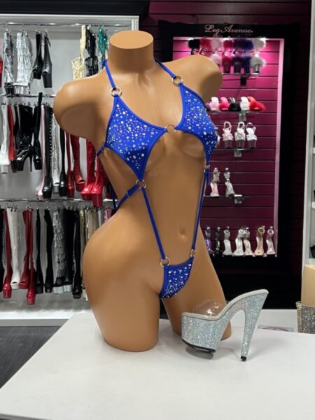 Blue O Ring Bodysuit with sparkling rhinestones, polished silver O-ring hardware, adjustable straps, daring cutout design, and a high-cut silhouette displayed on a mannequin.