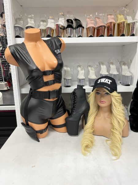 SWAT Costume Set featuring a faux leather tactical crop vest, matching shorts, adjustable utility belt, thigh holster, embroidered SWAT cap, and black platform boots displayed on a mannequin.