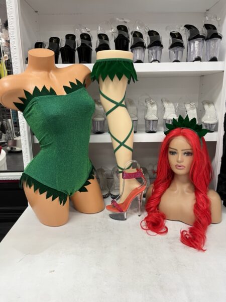 Botanical Bombshell costume with a green leaf-inspired bodysuit, matching leafy headpiece, and coordinating garter leg wrap.