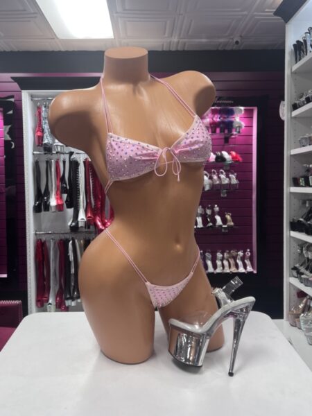 Baby pink rhinestone bikini set with tie-front top, halter straps, and high-cut string bottom.
