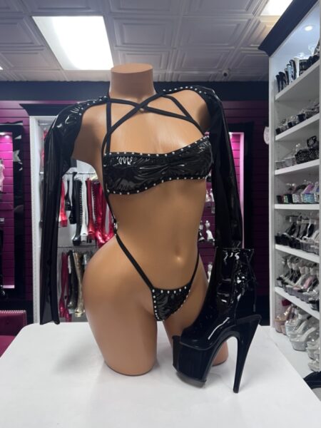 Black vinyl lingerie with rhinestone trim, long sleeves, strappy top, and high-cut bottom.
