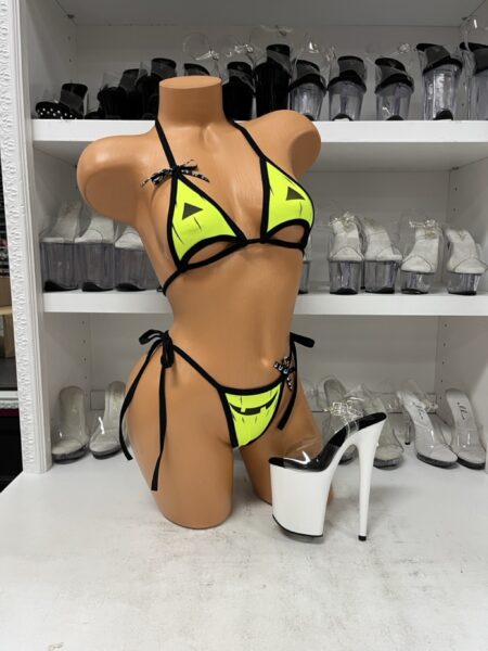 Neon Green Jack-O-Lantern Bikini Set featuring a neon lime green triangle halter top with black trim, pumpkin eyes, cutout details, and matching tie-side bikini bottom with a jack-o-lantern smile.