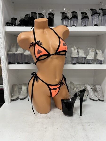Neon Orange Jack-O-Lantern Bikini Set featuring a bright orange triangle halter top with black pumpkin eyes, underbust cutouts, black trim, and matching tie-side bottoms with a jack-o-lantern smile.