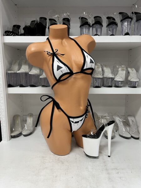 White Ghost Face Bikini Set featuring a white triangle halter top with black ghost eyes, decorative underbust cutouts, black trim, and matching tie-side bikini bottoms with a spooky smiling face.