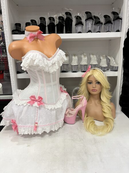 Bo Peep Carousel Costume featuring a white and pink corset, layered ruffle skirt, decorative bows, and matching fairytale accessories.
