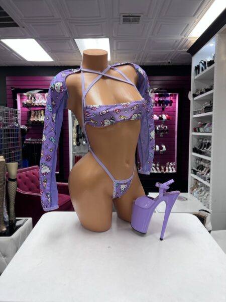 Lavender kitty sling set with cartoon print, strappy sling bottom, and matching long-sleeve top.