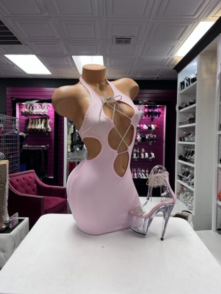 Baby Pink Crystal Cutout mini dress featuring soft pink fabric, a halter neckline, dramatic waist openings, and sparkling crystal lace-up details.