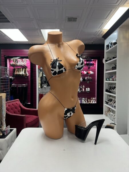 Onyx Cow Print Lingerie two-piece set with black and white cow-print triangle top, matching minimal bottom, thin black straps, and bow accents.
