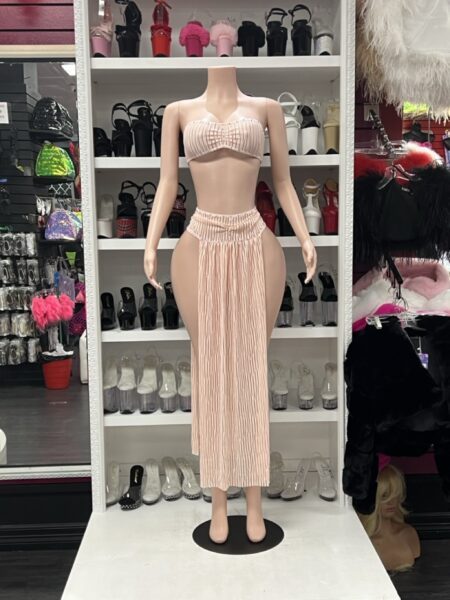 Blush Pleated Skirt Set with ruched bandeau crop top, gathered high waist, long pleated front panel, and dramatic open-side skirt design.