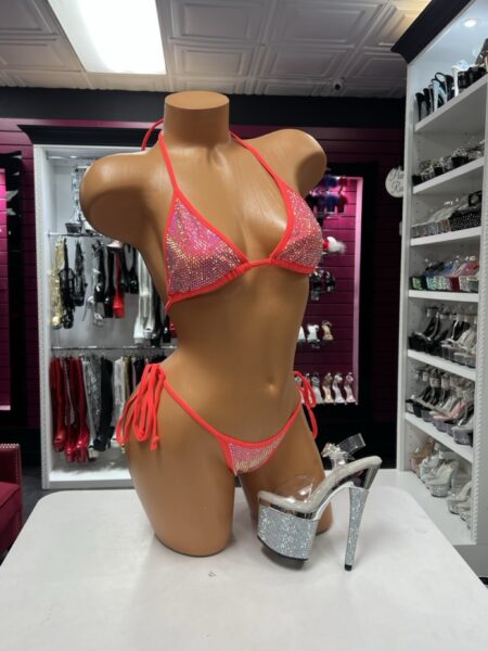 Neon coral crystal bikini two-piece lingerie set with rhinestone-covered triangle top, matching tie-side bottom, and sparkling crystal details.