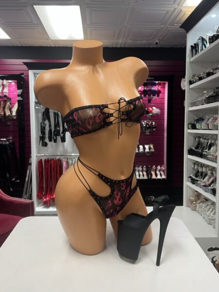 Pink Flame Bandeau Set featuring a sheer black strapless lace-up top with pink flame print, rhinestone accents, and matching strappy bottoms.