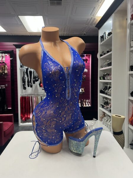 Royal Blue Crystal Romper featuring sheer floral lace, scattered rhinestone crystals, a plunging lace-up neckline, halter straps, and adjustable side ties.