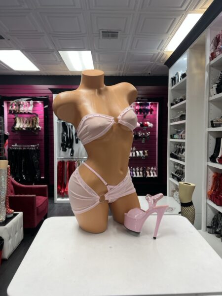 Blush Crystal Bandeau Set featuring a light blush pink strapless top with a center ring, sparkling rhinestone trim, and a matching asymmetrical mini skirt with an open hip cutout.