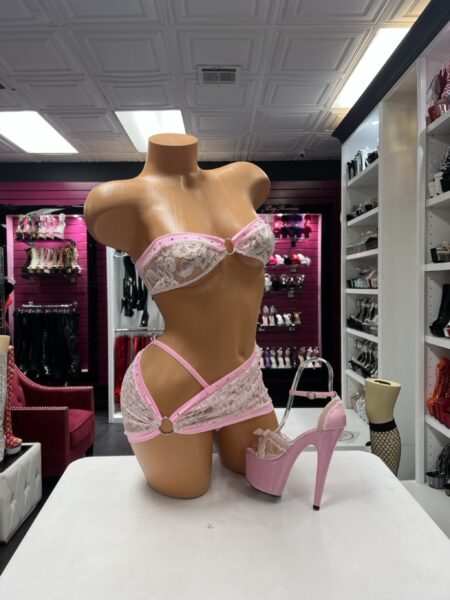 Pink Lace Bandeau Set featuring a white floral lace strapless top with pink trim, sparkling rhinestone accents, and matching asymmetrical lace mini skirt with a hip cutout.