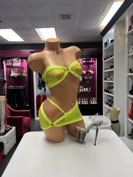 Lime Lace Bandeau Set featuring a bright lime green floral lace strapless top with rhinestone trim, a center metal ring, and a matching asymmetrical lace mini skirt with an open hip cutout.